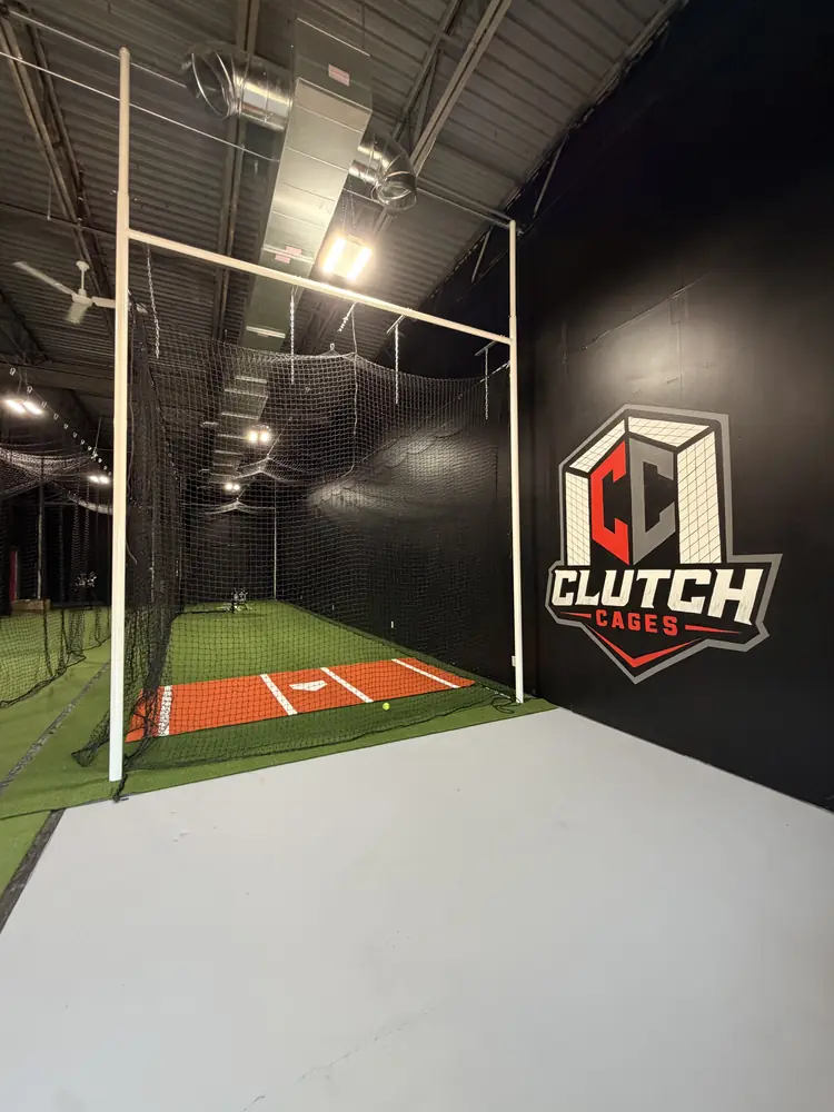 The Clutch Cages logo on the facility wall above the turf