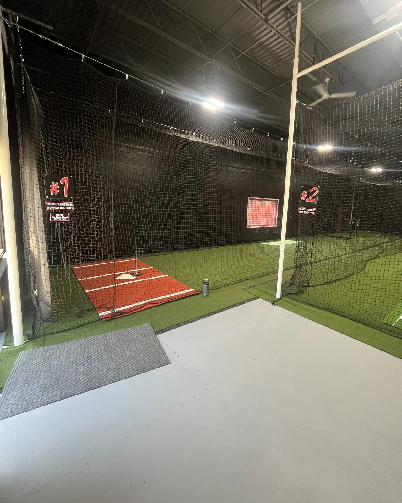 Both hitting tunnels at Clutch Cages, marked #1 and #2, with turf and home plate